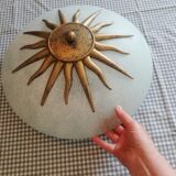 White opaque glass ceiling light and golden metal sun