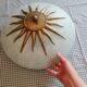 White opaque glass ceiling light and golden metal sun