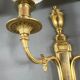 Set of three Louis XVI style wall sconces in gilded bronze, 20th century.