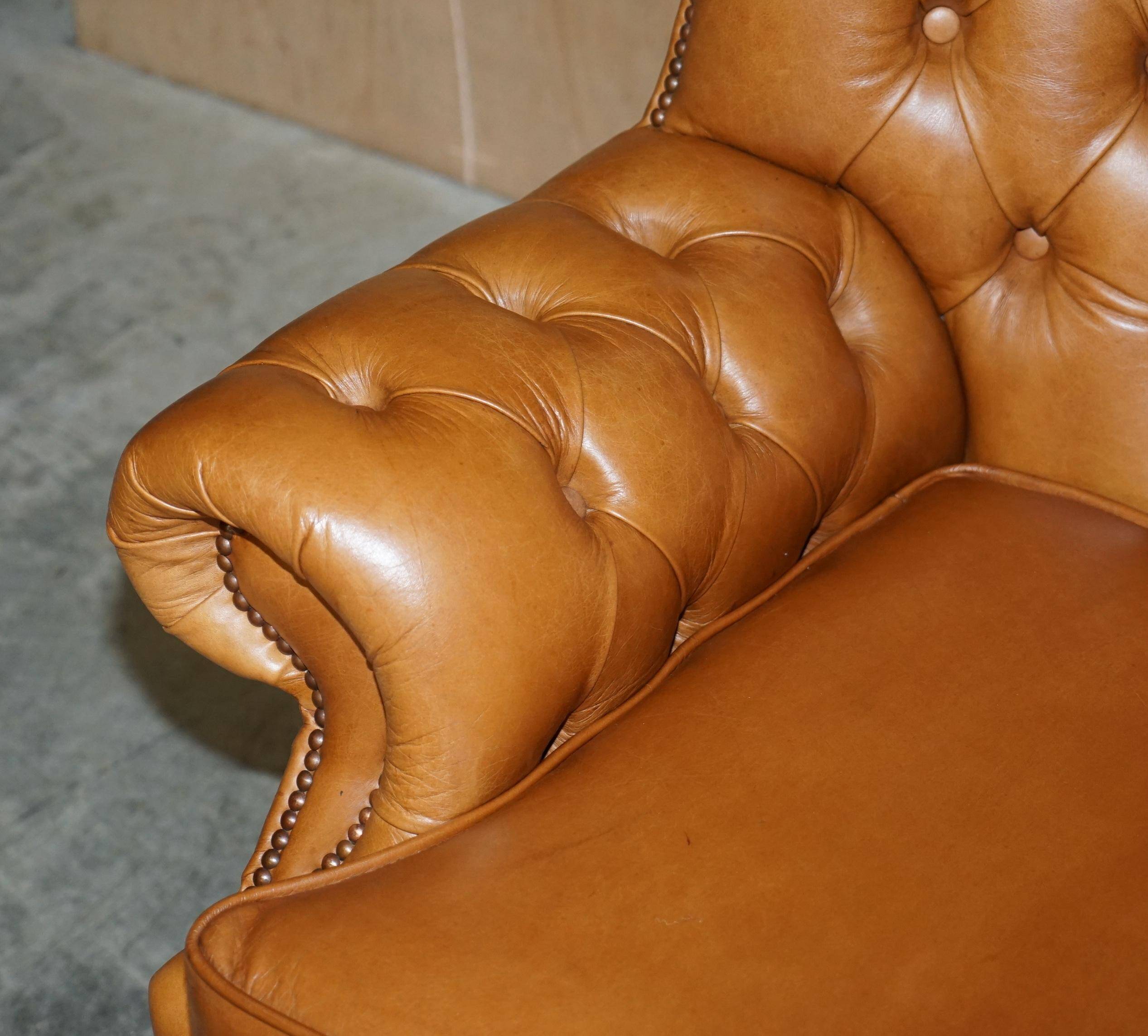Small Chesterfield leather sofa with a high back.