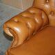 Small Chesterfield leather sofa with a high back.