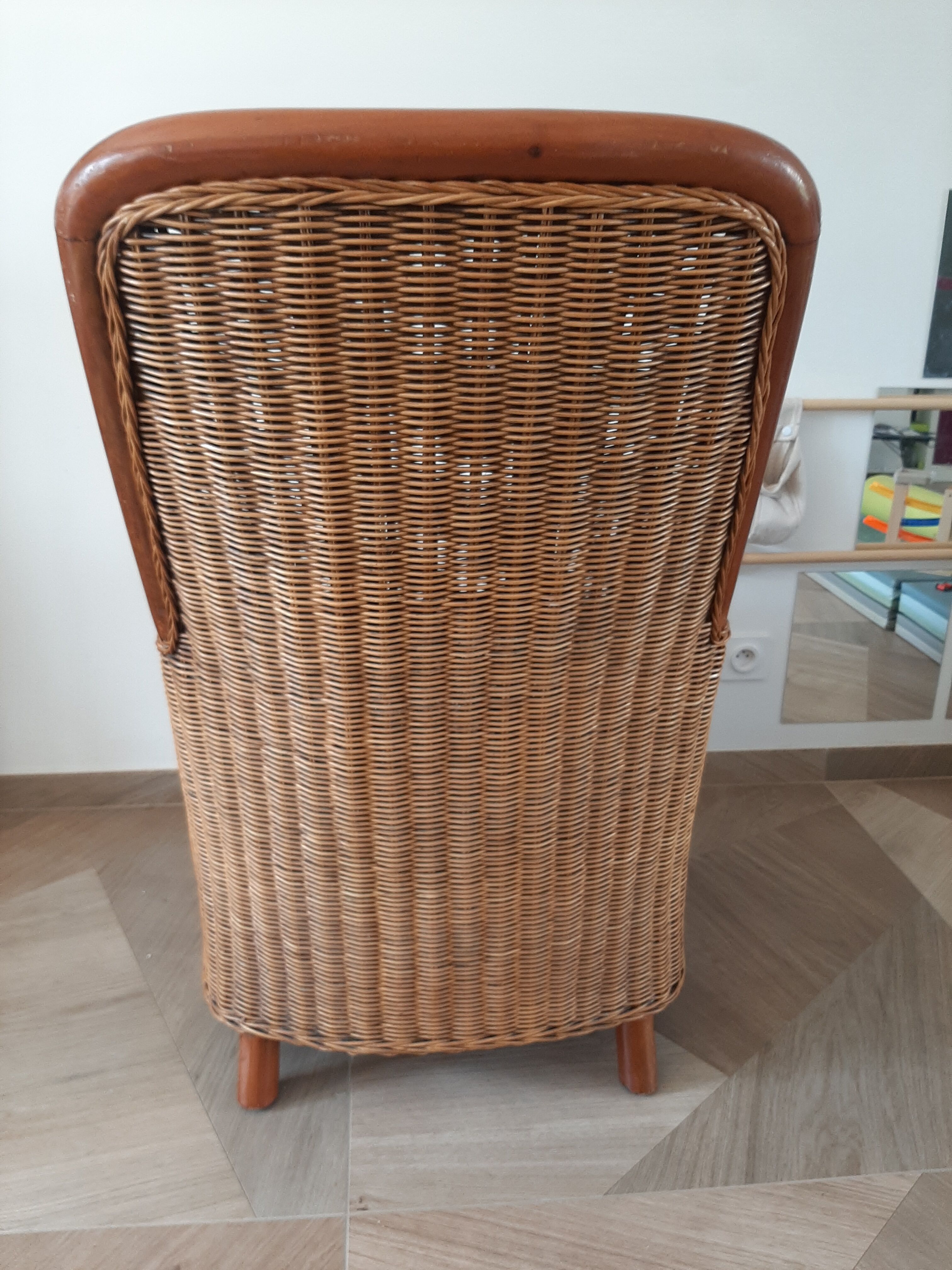 Armchair in woven rattan and exotic wood