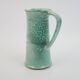 Large green ceramic pitcher with leopard enamel
