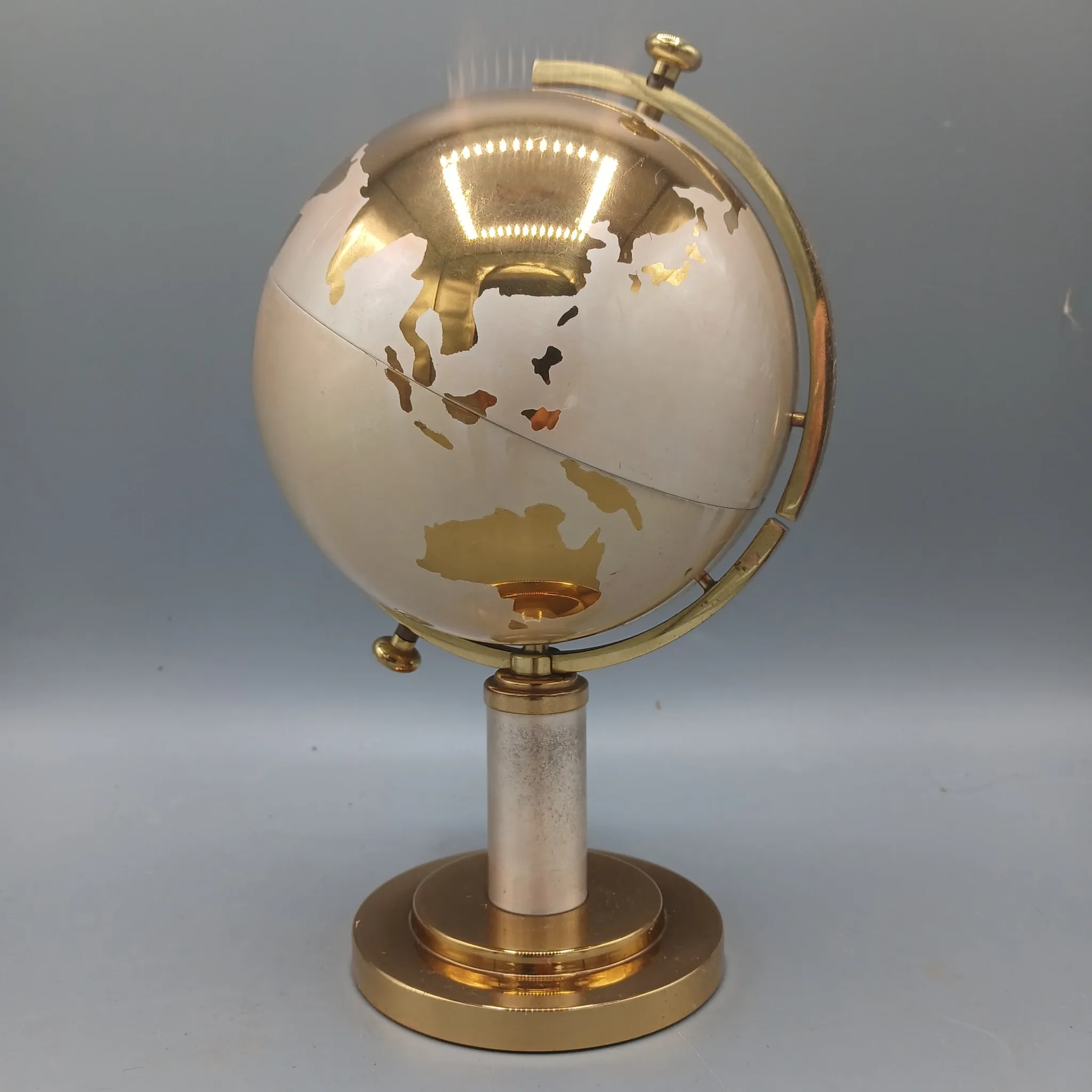 Vintage brass globe cigarette dispenser