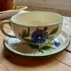Large cup and saucer in the quimper earthenware style.