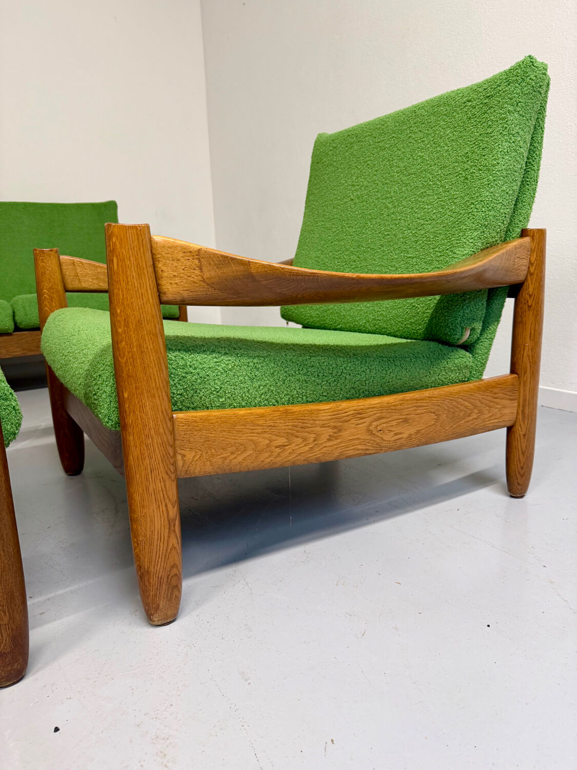 Living room sofa and Scandinavian design armchairs from the 1960s in green boucle.