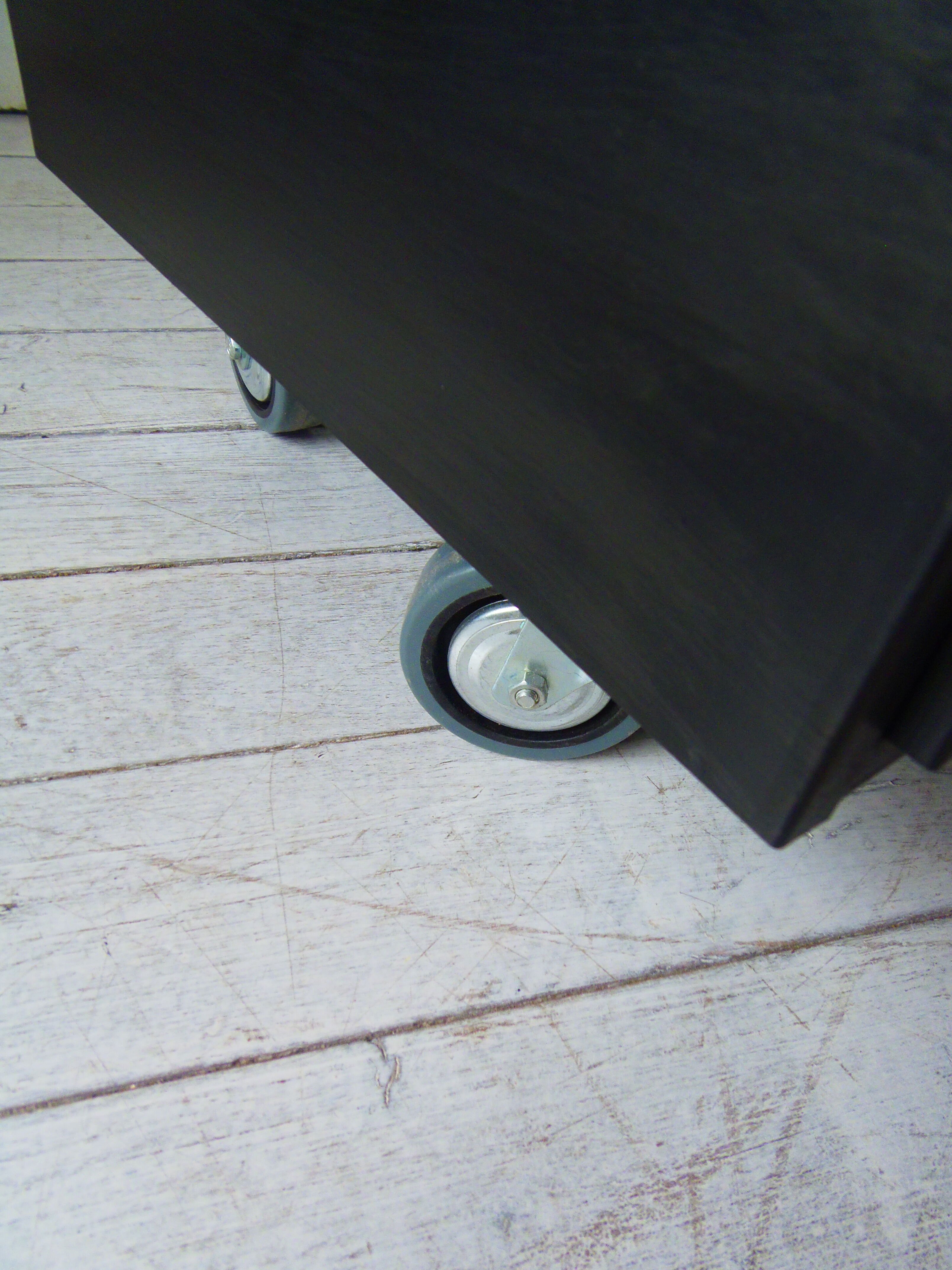 Vintage furniture with metal plugs on black wheels wooden tray