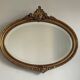 Antique oval gilt mirror.