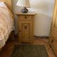 Vintage wooden bedside table painted brown, with a drawer and door, painted decoration from the 1890s.