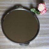 A large round mirror tray with metal handles