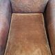 Antique club chair in patinated brown leather, early 20th century English style.