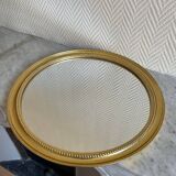 Round mirror with golden wood frame