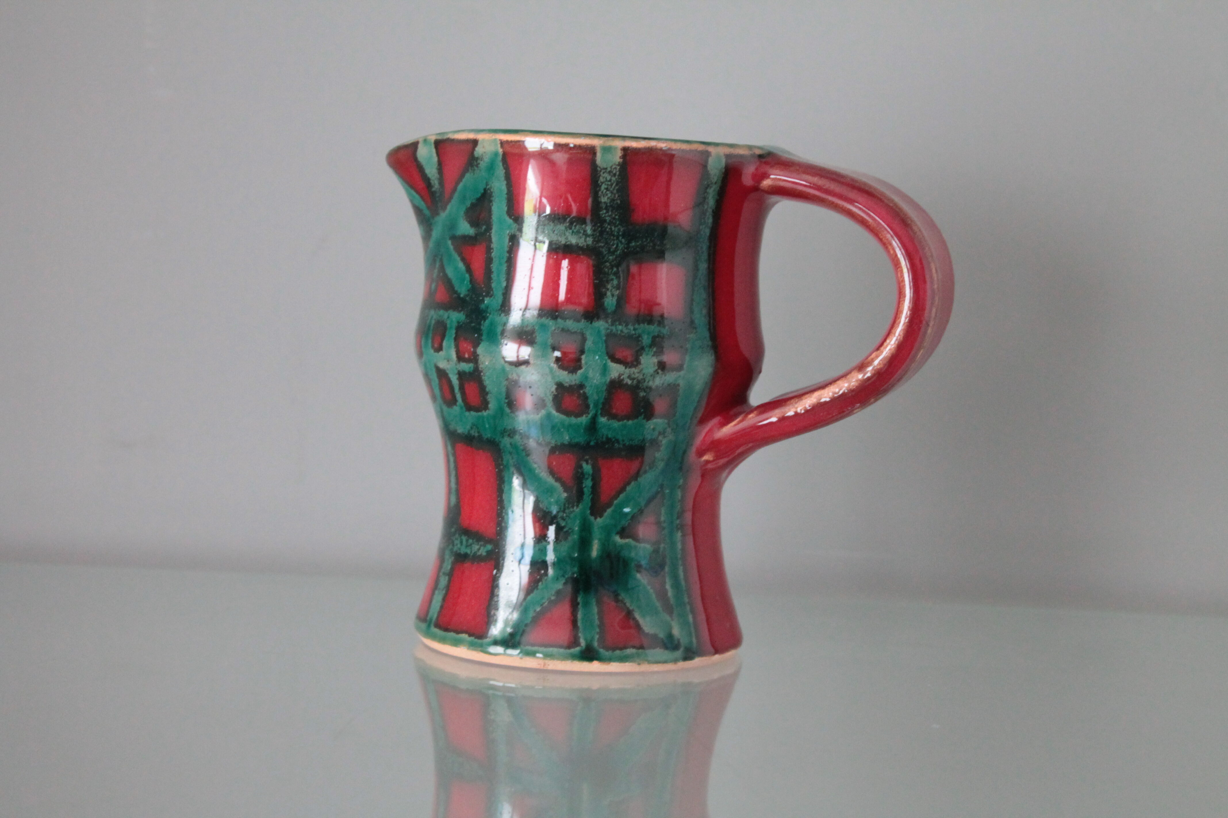 Vintage pitcher red and green art pottery