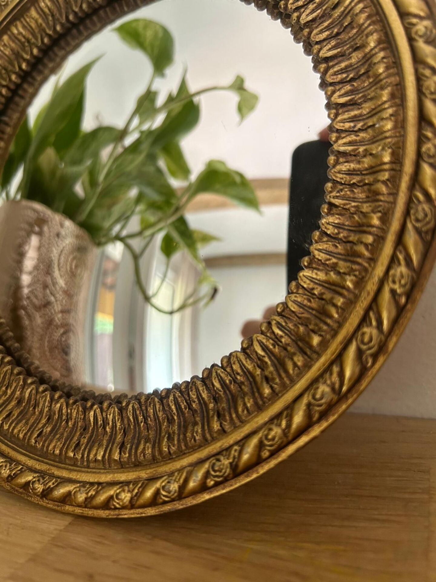 Round golden convex mirror with mouldings - witch's mirror