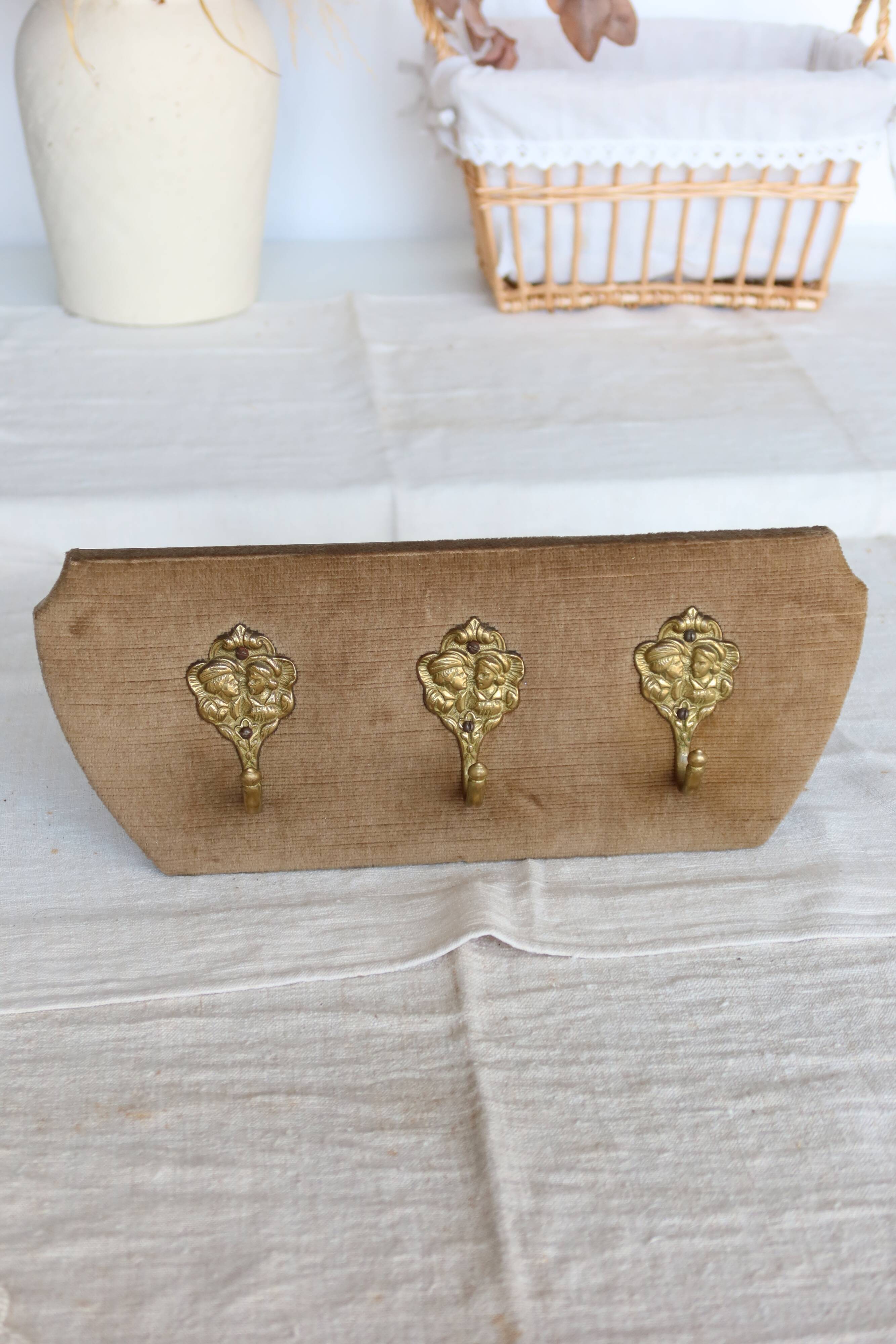 Vintage velvet coat rack with brass hooks
