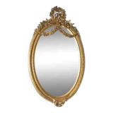 Oval mirror in Louis XVI style in wood and gilded stucco.