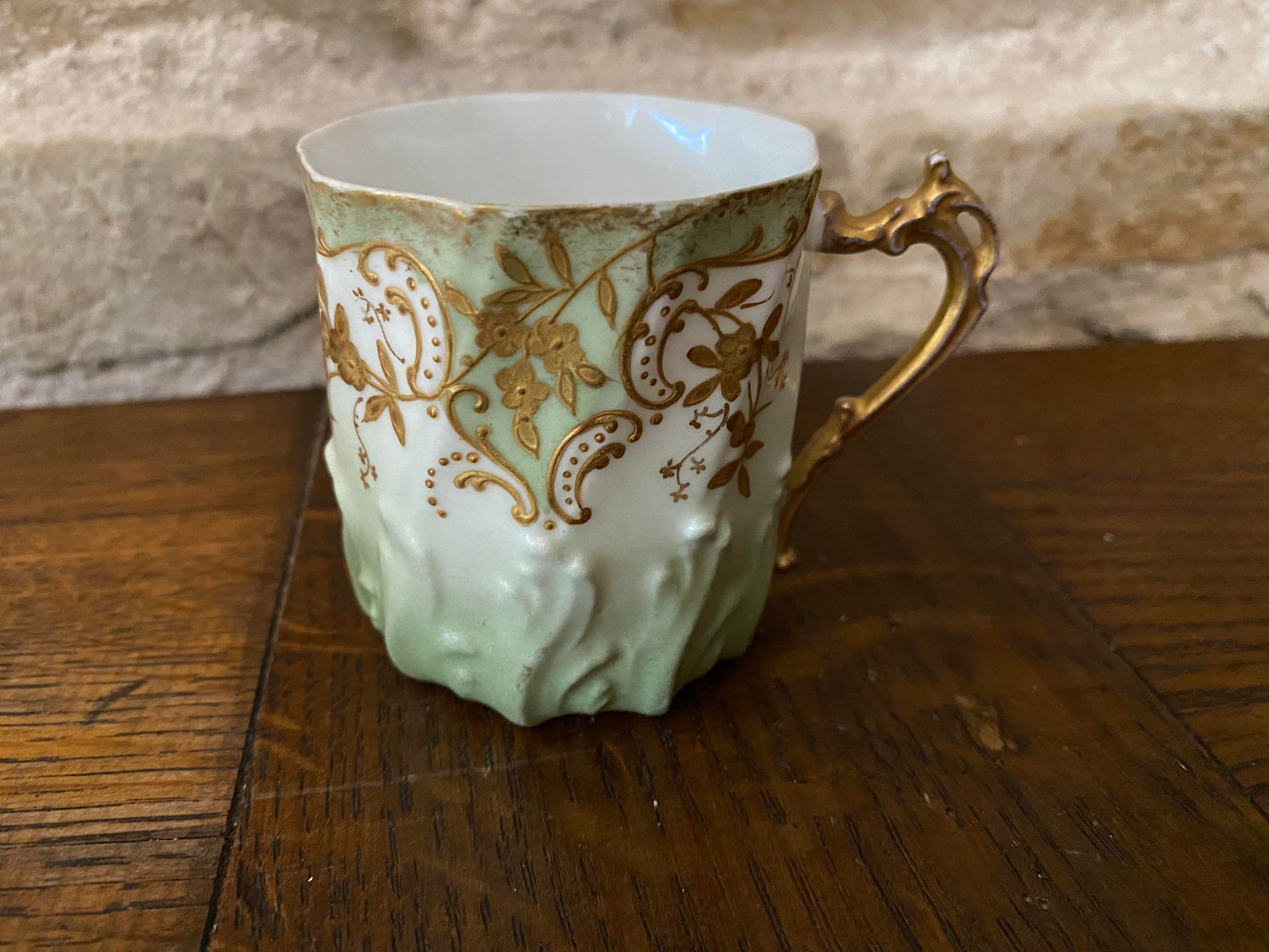 Extra fine porcelain cup pale green decorations and gilding