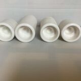 Four white earthenware candle holders