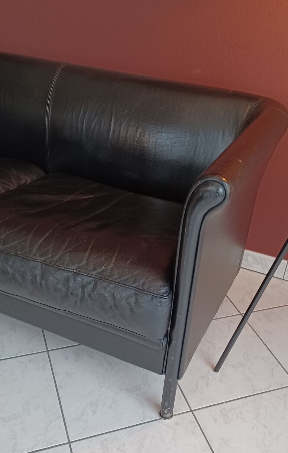 Black leather two-seater sofa