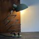 Old extendable accordion lamp in celadon green, workshop spirit.
