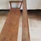 Church bench in fir tree with armrests
