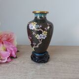 Small black cloisonné vase decorated with yellow and pink cherry blossoms, vase on wooden base