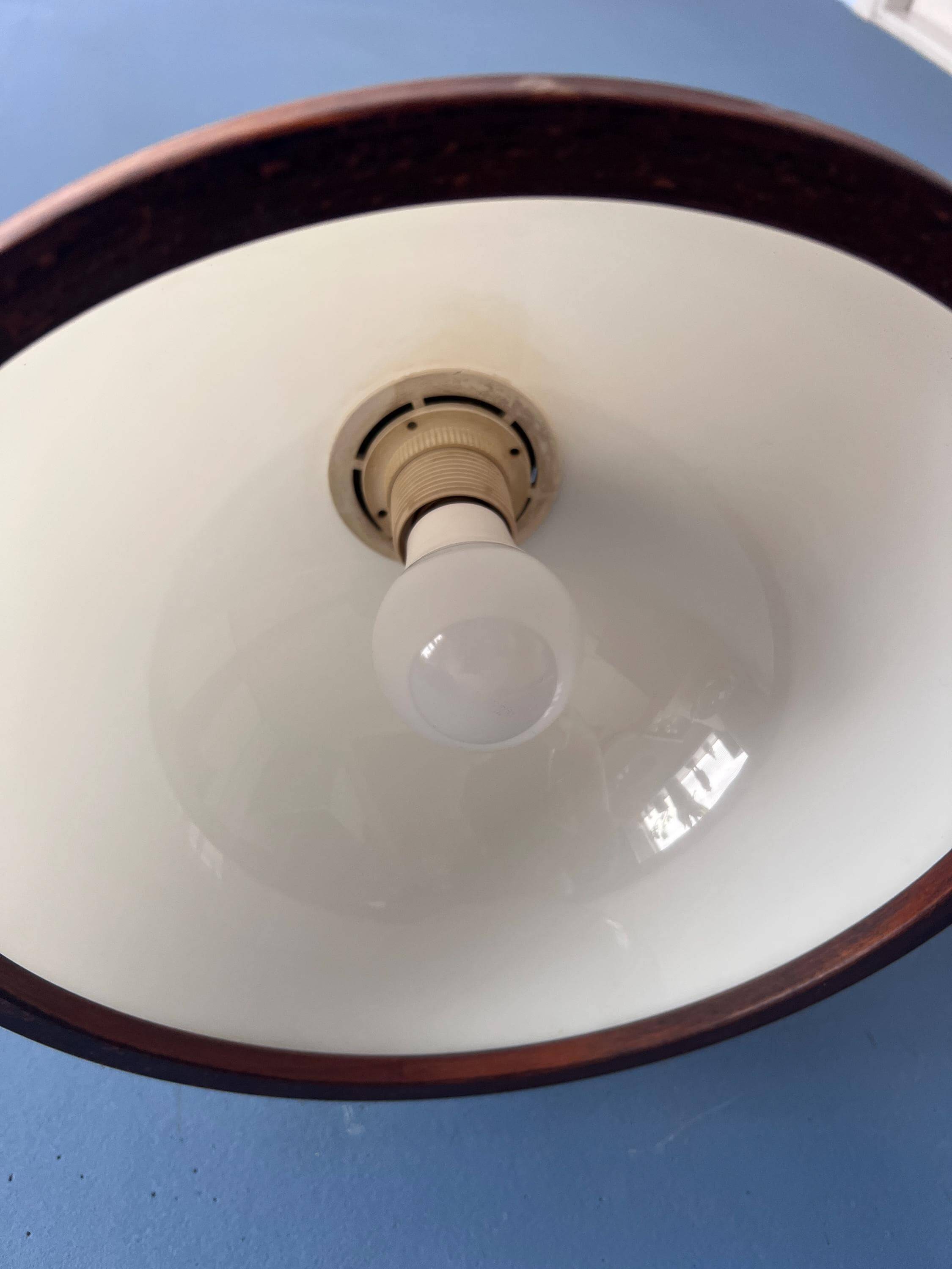 Mid-century floor lamp in brown wood by Steinhauer with an acrylic glass shade.