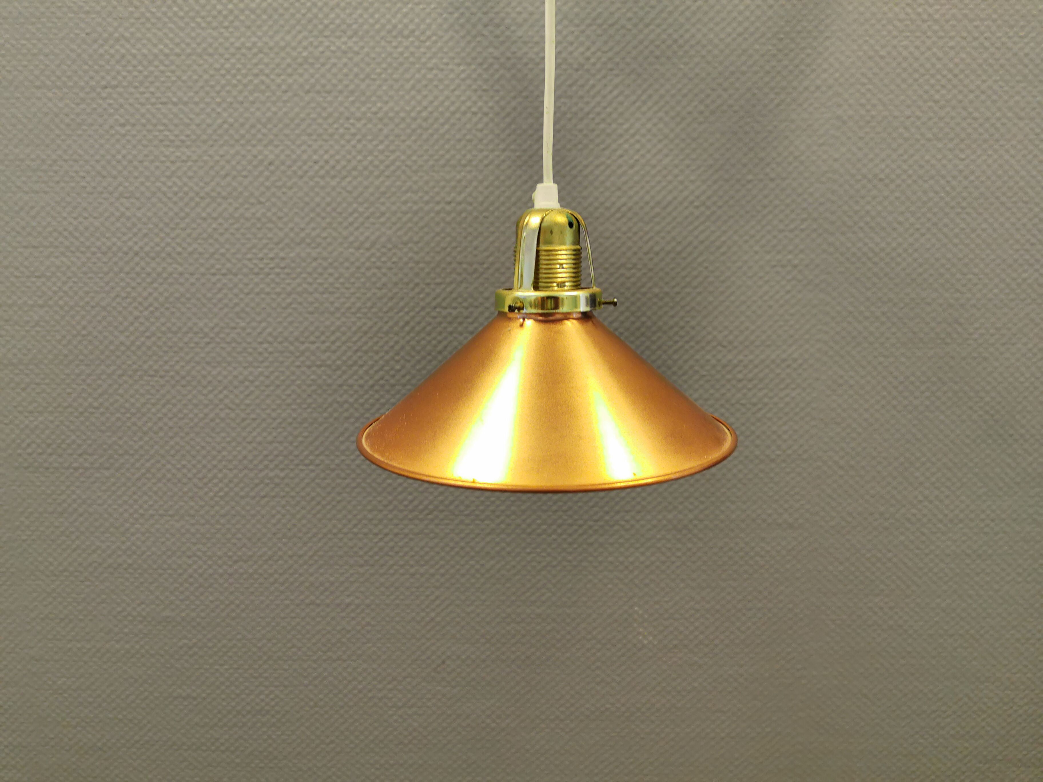 Copper hanging lamp with brass colored top and white inside lacquer.