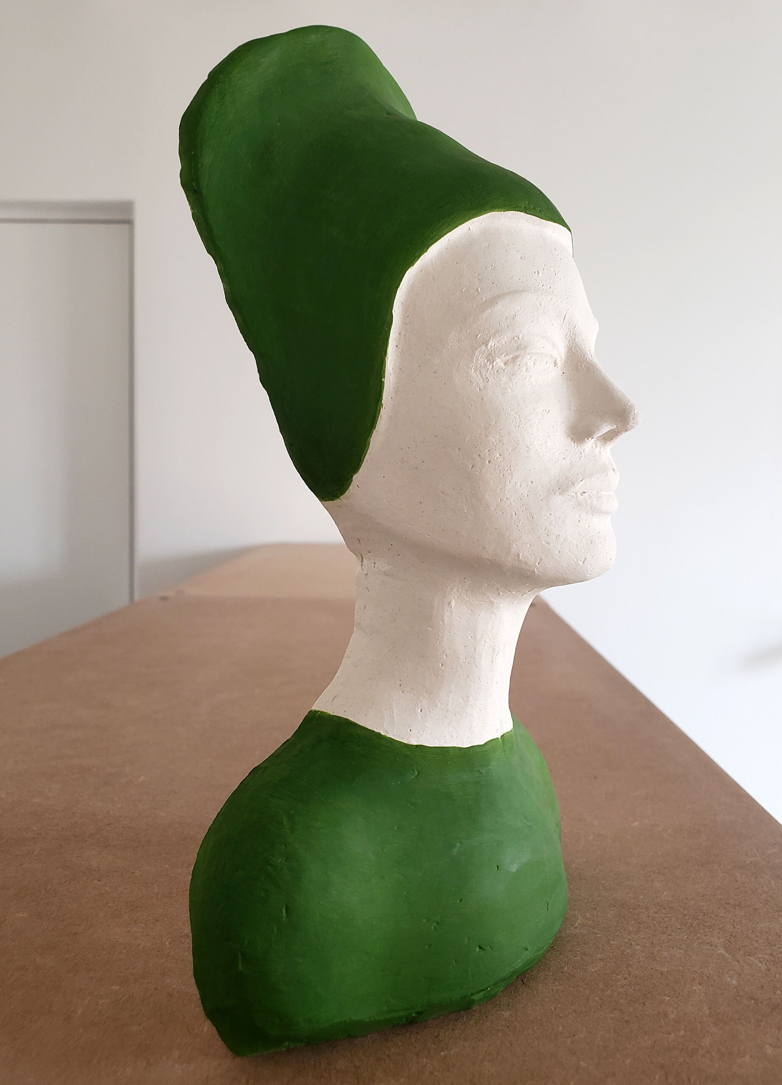 Bust of a woman in green and white plaster