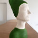 Bust of a woman in green and white plaster