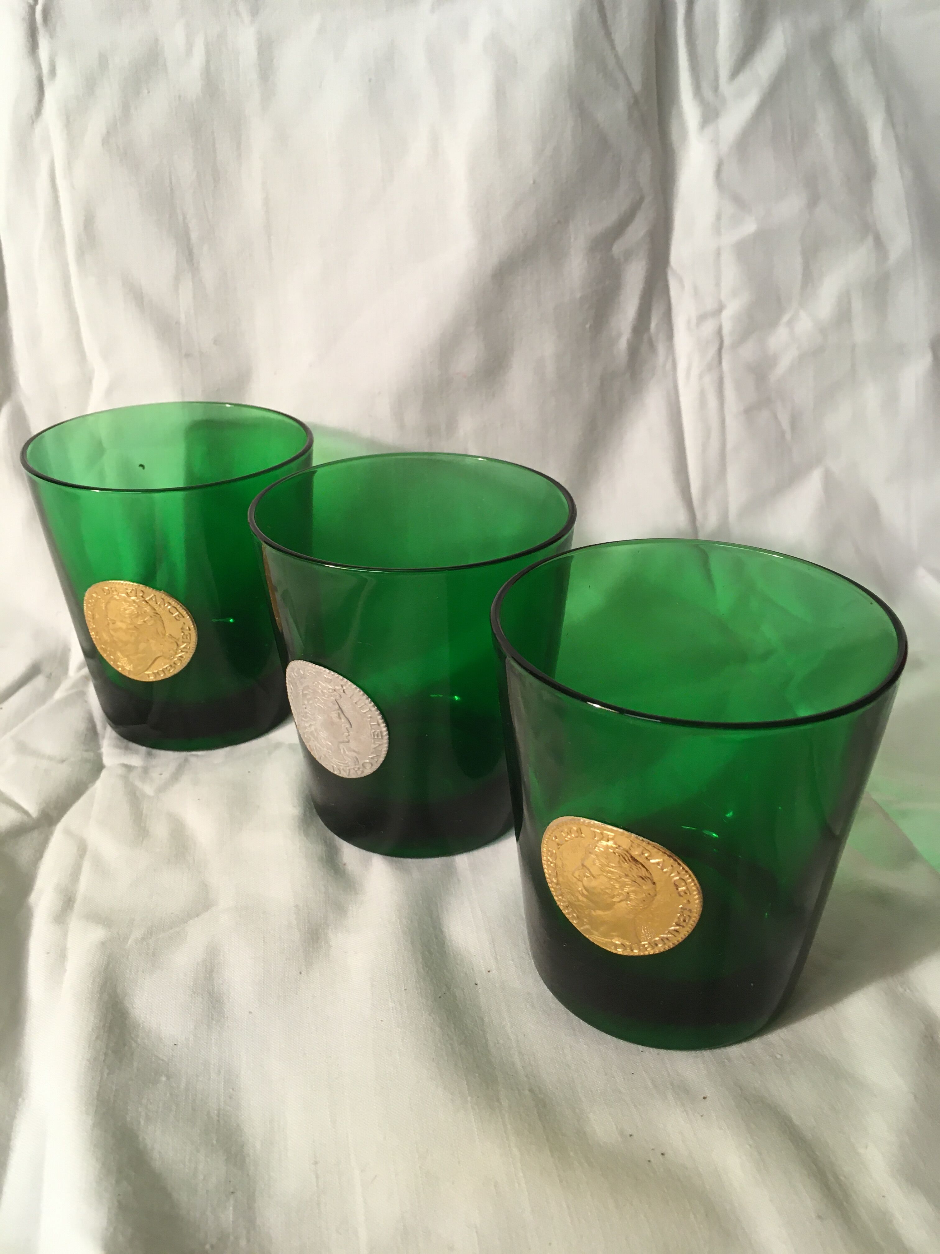 3 green glasses with silver gold shields