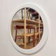Large vintage round mirror with a white border.
