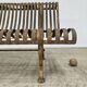 Cast iron garden bench from the late 19th century with slatted backrest.