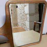 Old beveled hand mirror and wooden frame