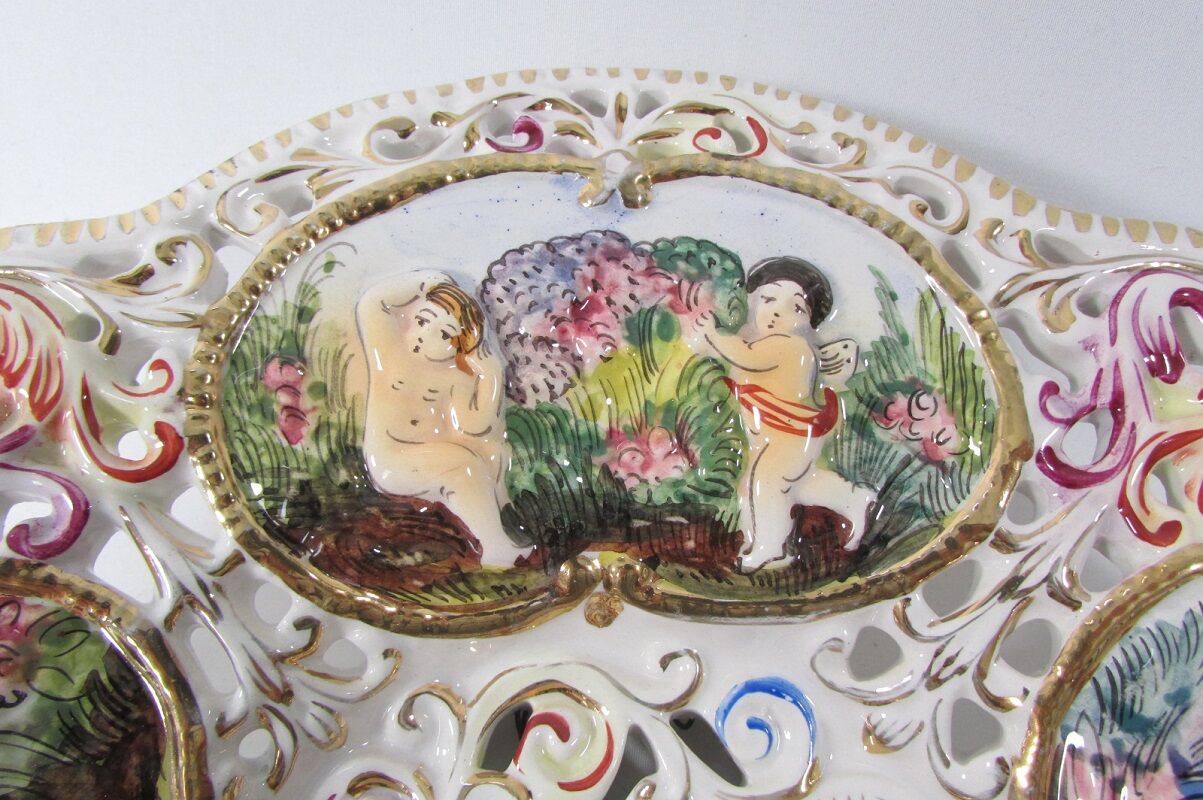 Capedimonté openwork plate, 4 seasons putto
