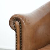 Characterful club chair made of sheepskin leather with light cognac colours