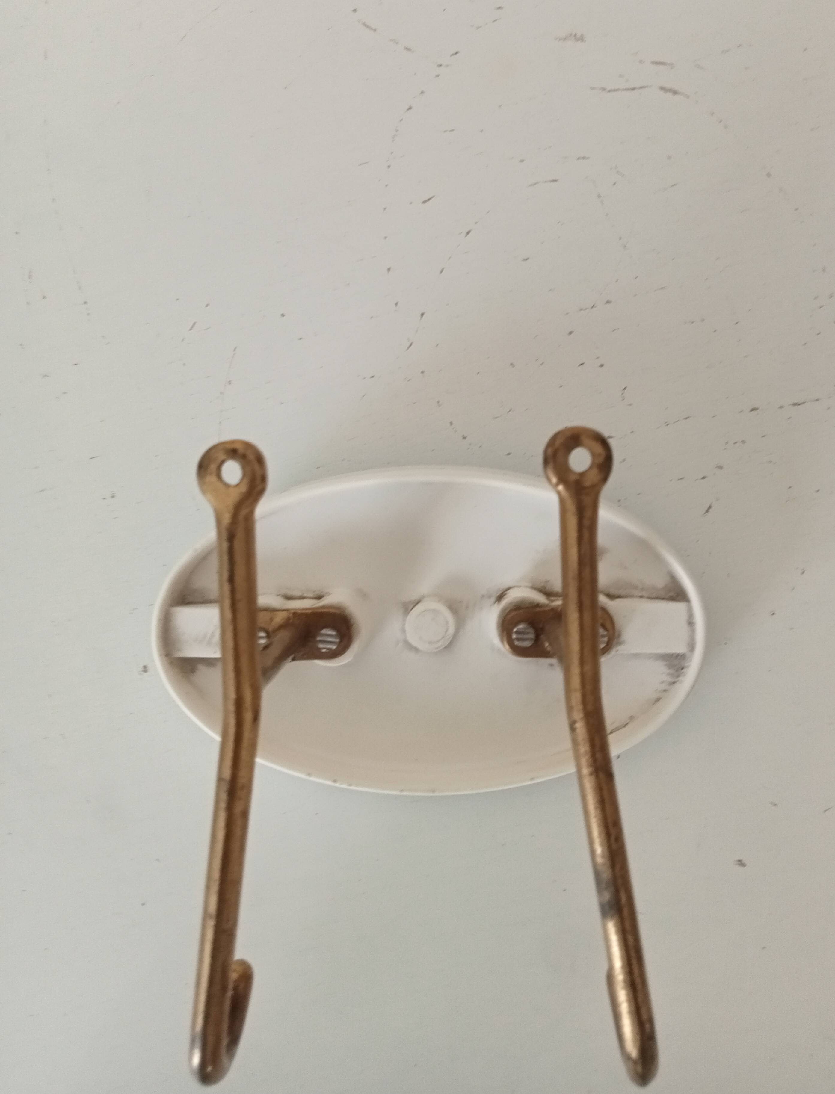 Vintage wall coat hook in brass and Bakelite.