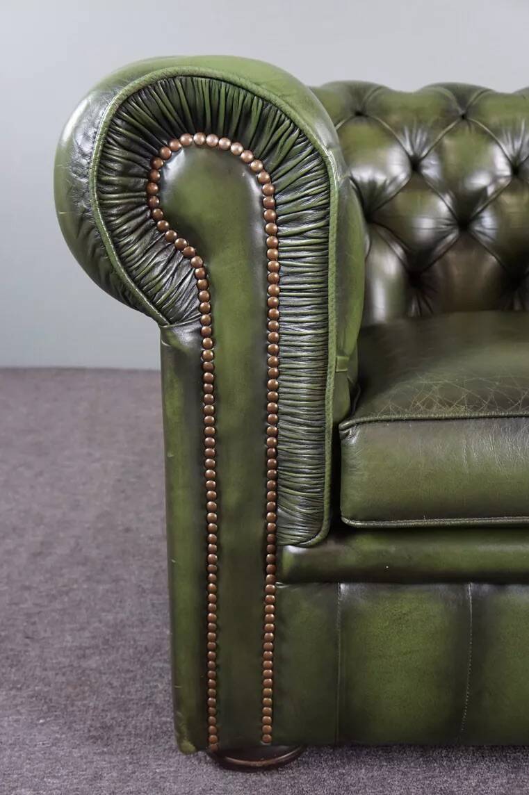 Spacious Chesterfield armchair in green patina