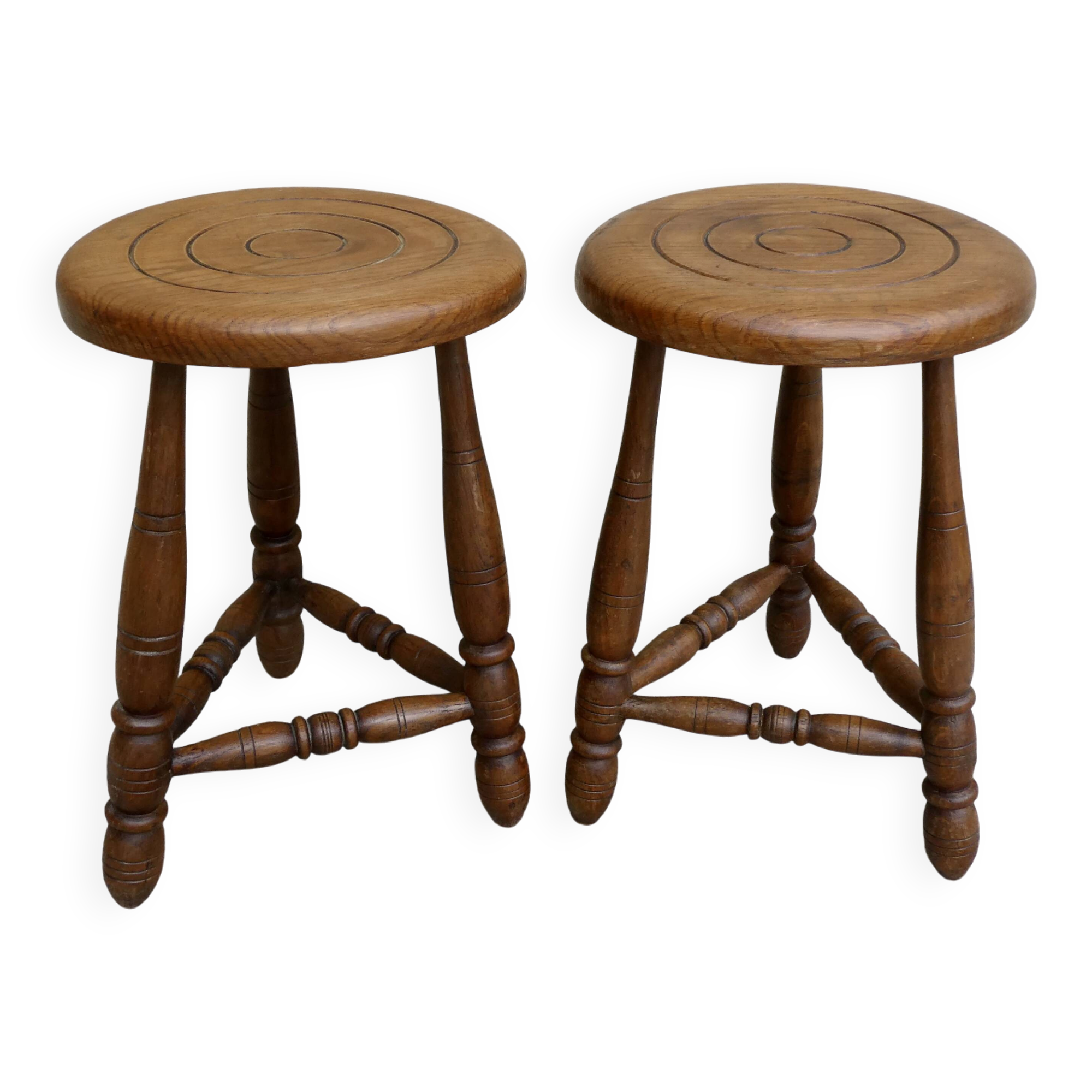 Pair of solid wood tripod stools, carved.