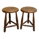 Pair of solid wood tripod stools, carved.