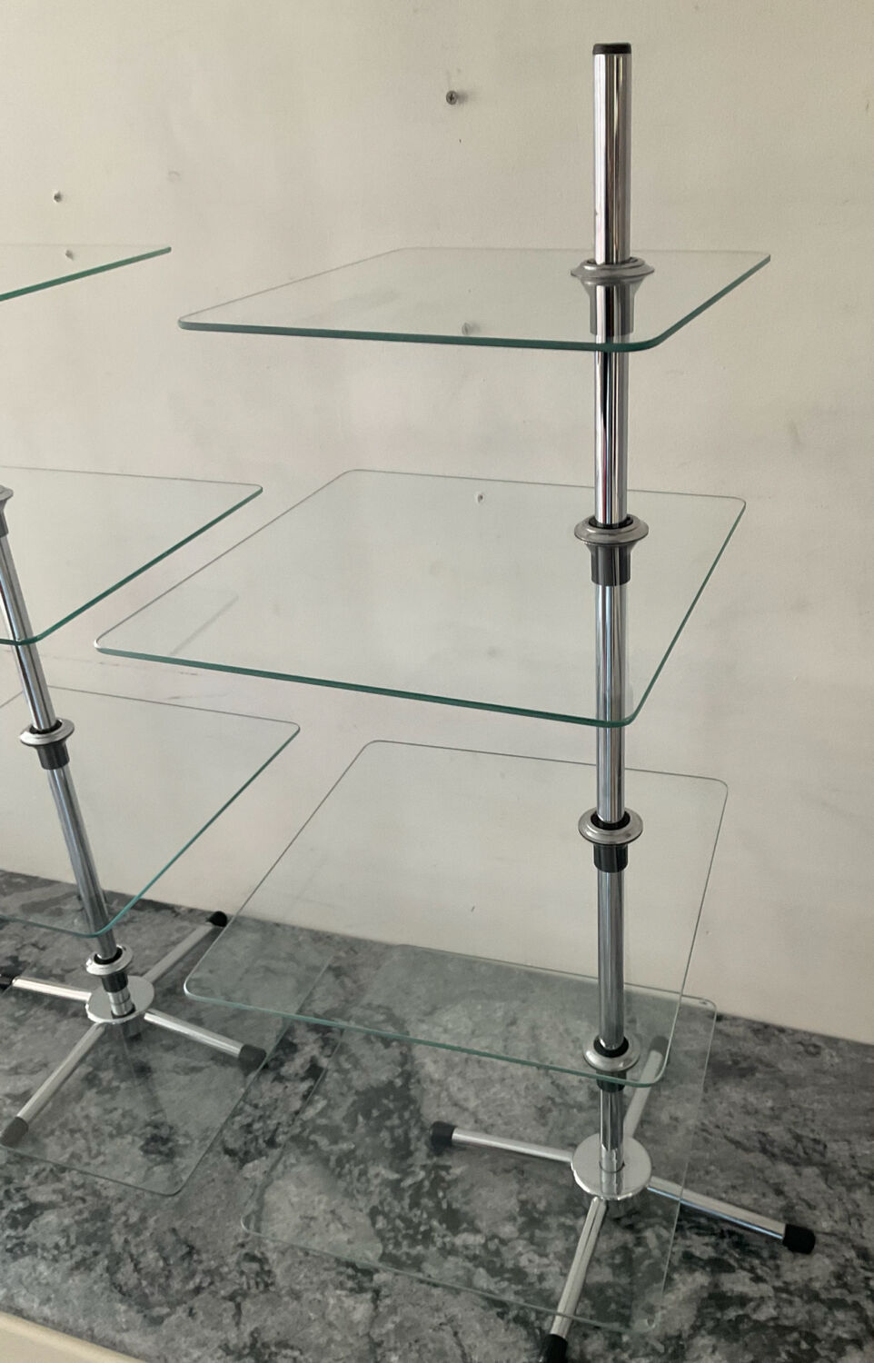 A pair of vintage side tables in glass and chrome metal.