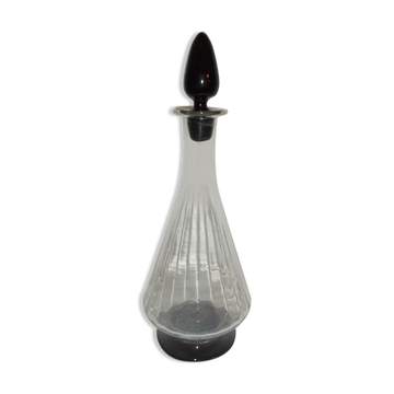 Dark purple glass wine carafe with a stopper.