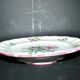 Round plate on pedestal, floral mounted dish, moonlight street lamp.
