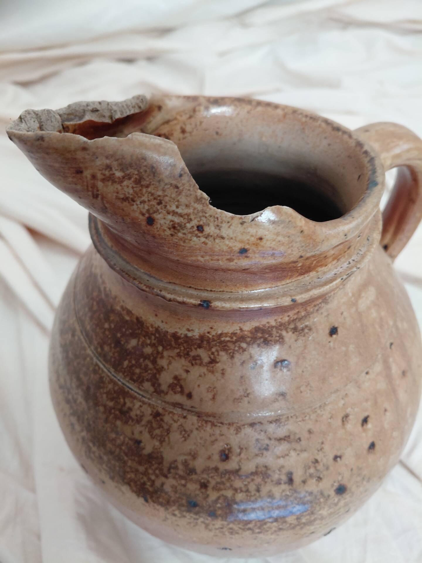 Old farm jug in glazed stoneware