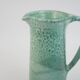 Large green ceramic pitcher with leopard enamel