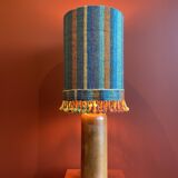 "Stoneware Bottle Lamp" with a multicoloured blue lampshade handwoven in India.