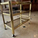 Serving table with wheels, gold-plated brass, smoked glass