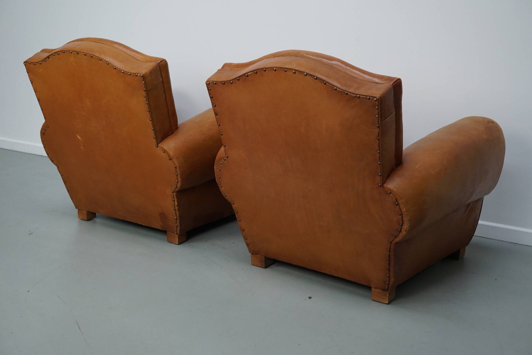 Pair of French club chairs with moustache back in cognac leather, 1950s