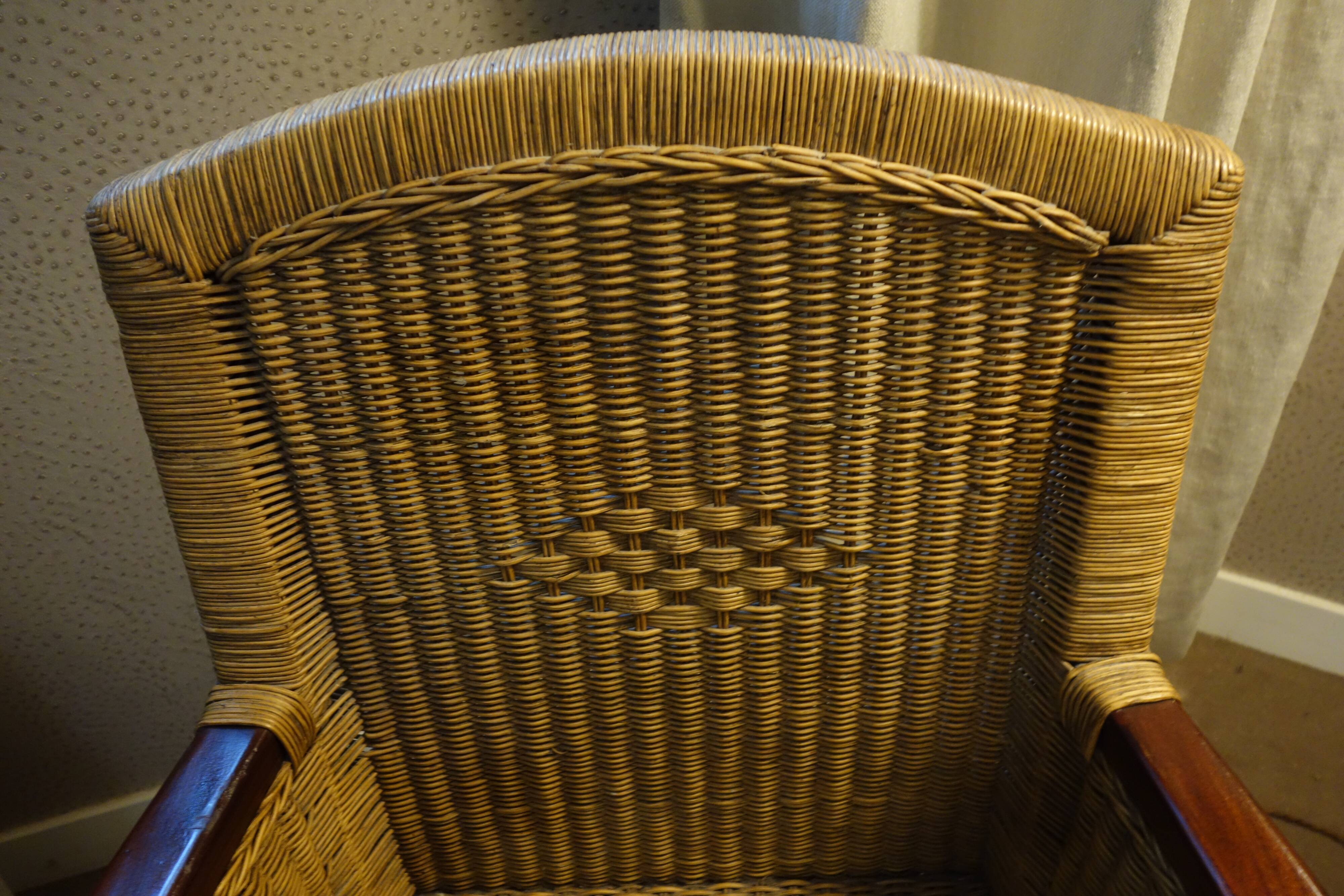 comfortable colonial-style armchair in rattan and mahogany