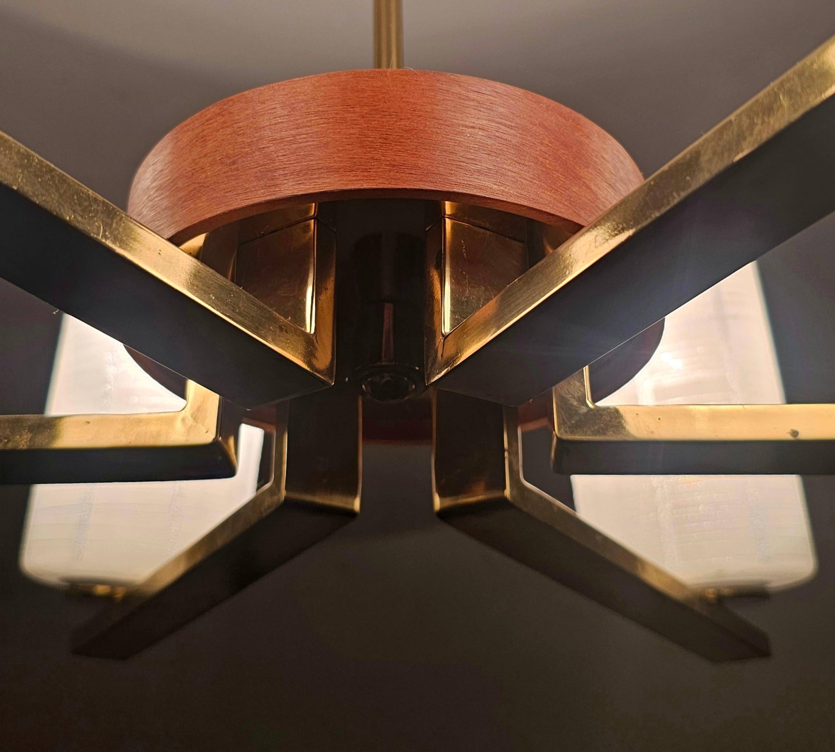Lustre Mid Century Modern with 6 brass arms, teak, and frosted glass.